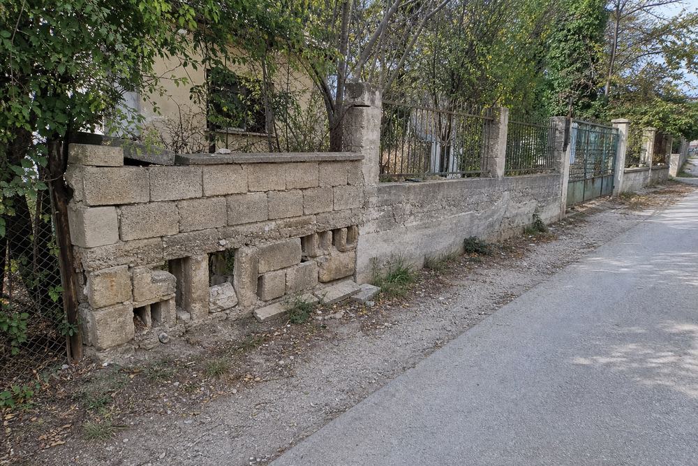 Sample demo before image of a crumbling old boundary wall with missing blocks
