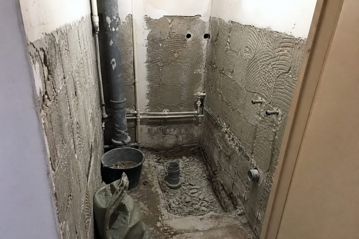 Sample demo image of a small Bulgarian apartment bathroom stripped back for renovation with exposed plumbing